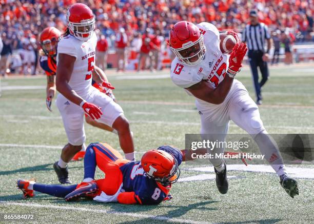 Gus Edwards of the Rutgers Scarlet Knights runs the ball as Dawson DeGroot of the Illinois Fighting Illini attempts the tackle at Memorial Stadium on...
