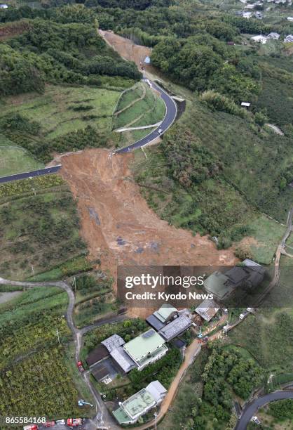 Photo taken Oct. 23 from a Kyodo News helicopter, shows a landslide hitting houses in Kinokawa city, Wakayama Prefecture, as torrential rains struck...