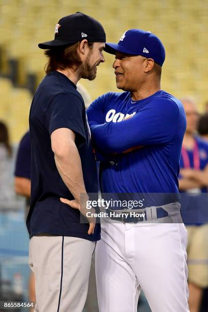 Josh Reddick of the Houston Astros talks with manager Dave Roberts of the Los Angeles Dodgers on the field ahead of the World Series at Dodger...