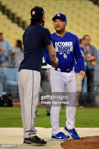 Josh Reddick of the Houston Astros talks with manager Dave Roberts of the Los Angeles Dodgers on the field ahead of the World Series at Dodger...