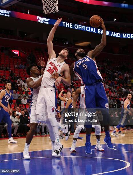 Jon Leuer of the Detroit Pistons and Amir Johnson of the Philadelphia 76ers ballet for ball control during the second quarter of the game at Little...