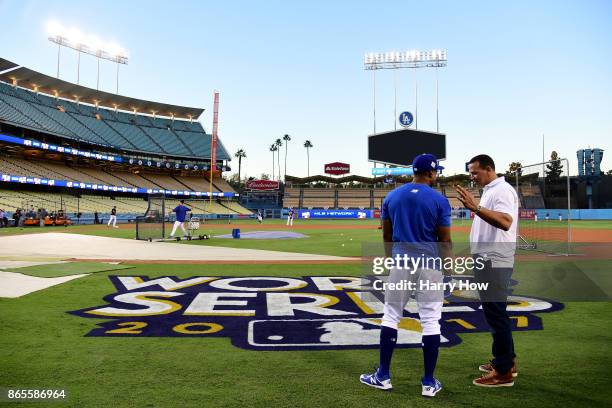 Curtis Granderson of the Los Angeles Dodgers talks with Alex Rodriguez of Fox Sports on the field ahead of the World Series at Dodger Stadium on...