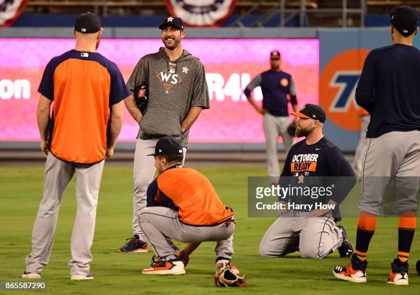Justin Verlander of the Houston Astros talks with his teammates during practice ahead of the World Series at Dodger Stadium on October 23, 2017 in...