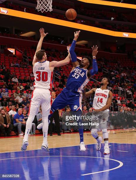 Robert Covington of the Philadelphia 76ers drives the ball to the basket as Jon Leuer and Ish Smith of the Detroit Pistons defend during the NBA game...