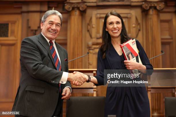 Prime Minister-designate Jacinda Ardern and NZ First leader Winston Peters shake hands during a coalition agreement signing at Parliament on October...