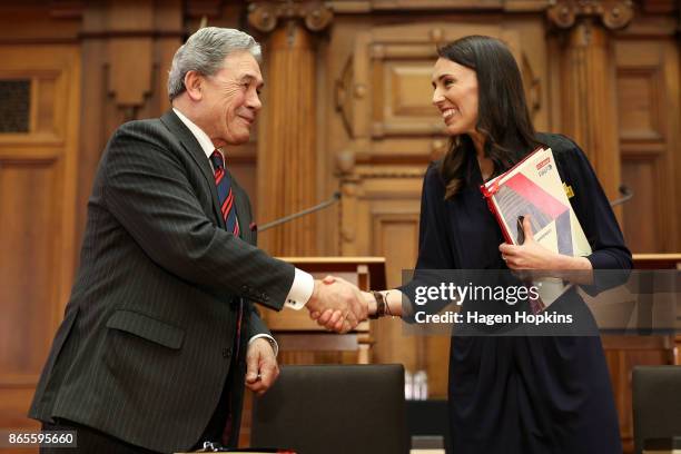 Prime Minister-designate Jacinda Ardern and NZ First leader Winston Peters shake hands during a coalition agreement signing at Parliament on October...