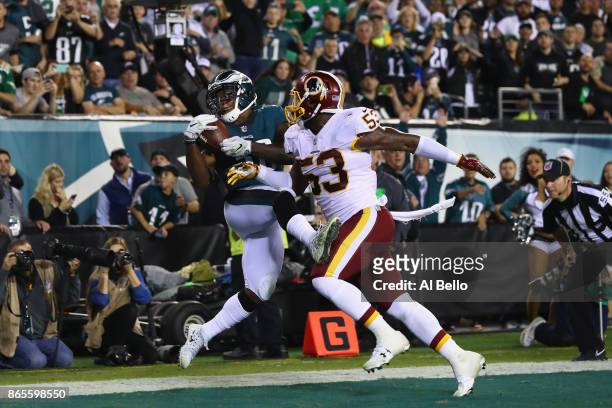 Corey Clement of the Philadelphia Eagles makes a catch to go 9-yards and score a touchdown against Zach Brown of the Washington Redskins during the...