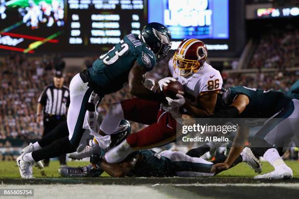 Jordan Reed of the Washington Redskins scores a touchdown against Nigel Bradham, Joe Walker and Patrick Robinson of the Philadelphia Eagles in the...