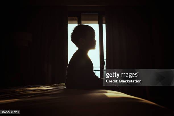 a boy in the bedroom - solitario foto e immagini stock