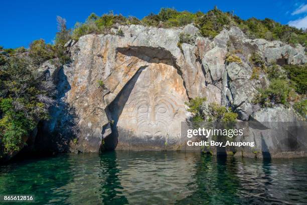 the maori rock carvings in great lake taupo in north island of new zealand. - maori art stock pictures, royalty-free photos & images