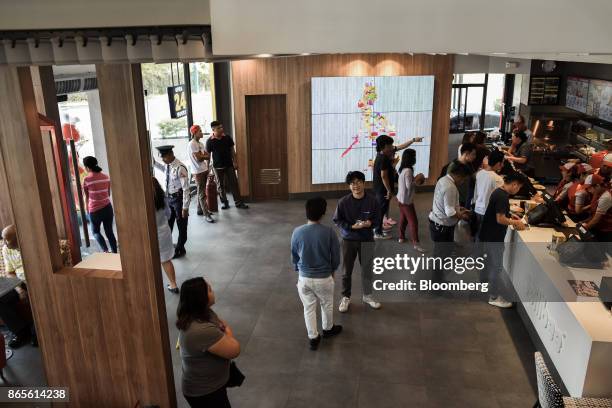 Customers place orders at a Jollibee Foods Corp. Restaurant in the Bonifacio Global City triangle area of Manila, the Philippines, on Saturday, Oct....