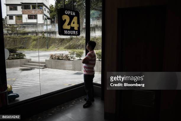 Customer stands at a window of a Jollibee Foods Corp. Restaurant in Bonifacio Global City triangle in the Philippines, on Saturday, Oct. 21, 2017....
