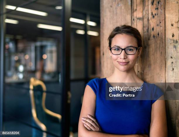 portrait of confident businesswoman in office - 30 year old woman stock pictures, royalty-free photos & images