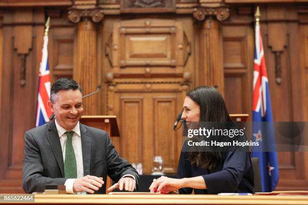 Prime Minister-designate Jacinda Ardern and Green Party leader James Shaw sign documents during a confidence and supply agreement signing at...