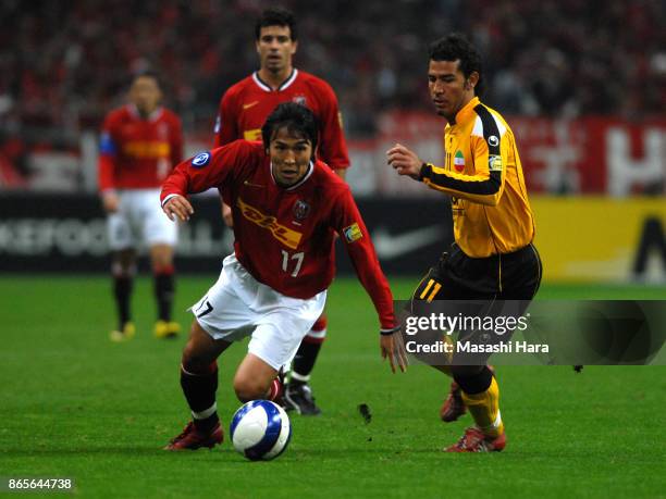 Makoto Hasebe of Urawa Red Diamonds and Hossein Kazemi of Sepahan compete for the ball during the AFC Champions League final second leg match between...