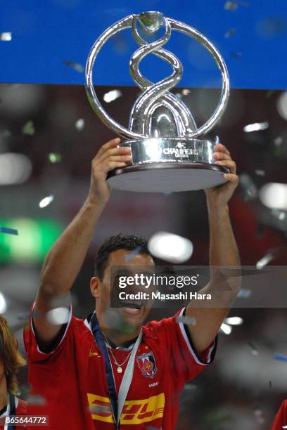 Washington of Urawa Red Diamonds lifts the trophy after the AFC Champions League final second leg match between Urawa Red Diamonds and Sepahan at...
