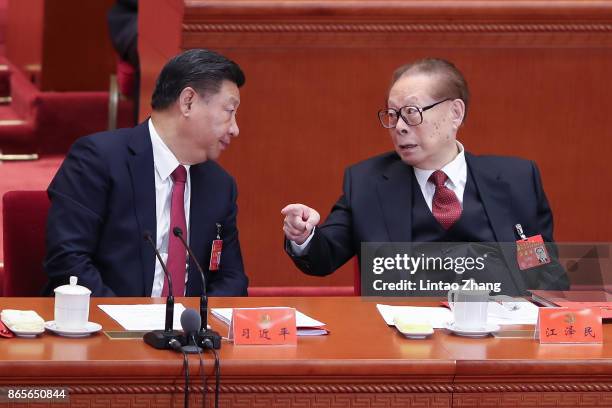 Chinese President Xi Jinping talk with China's former president Jiang Zemin during the closing of the 19th Communist Party Congress at the Great Hall...