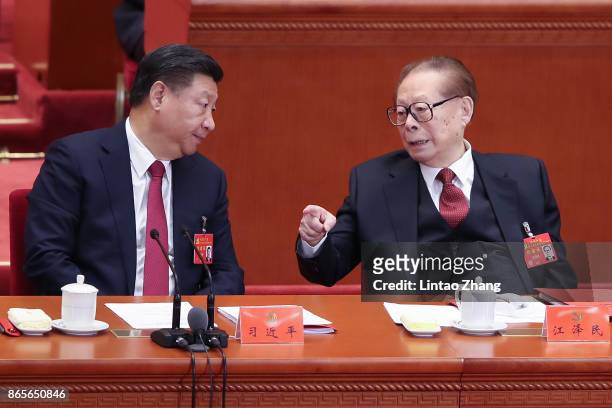 Chinese President Xi Jinping talk with China's former president Jiang Zemin during the closing of the 19th Communist Party Congress at the Great Hall...