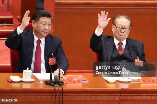 Chinese President Xi Jinping with China's former president Jiang Zemin vote at the closing of the 19th Communist Party Congress at the Great Hall of...