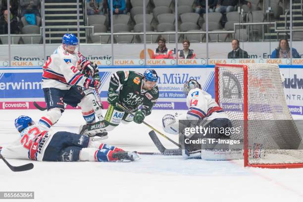 Marcel Goc of Adler Mannheim , Denis Reul of Adler Mannheim , Gabe Guentzel of Augsburger Panther and Dennis Endras of Adler Mannheim battle for the...