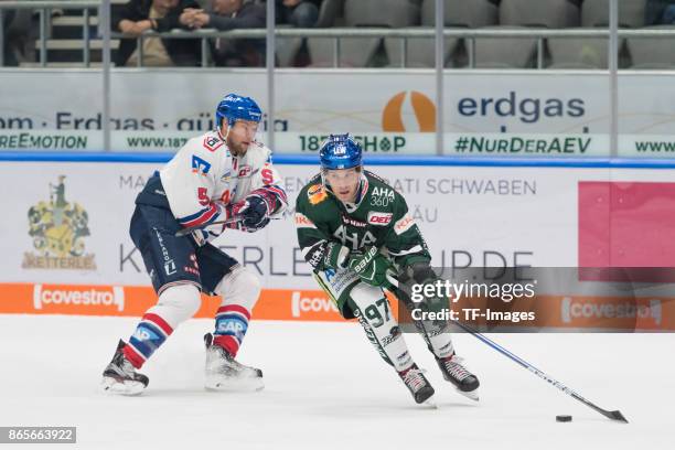 Aaron Johnson of Adler Mannheim and Matt White of Augsburger Panther battle for the ball during the DEL match between Augsburger Panther and Adler...