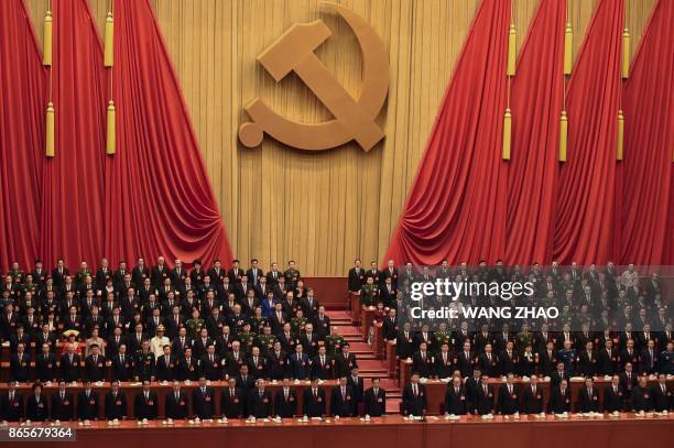 Delegates listen to the Internationale at the end of the closing session of the 19th Communist Party Congress at the Great Hall of the People in...