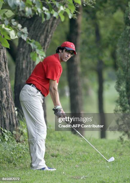 In this picture taken 19 September 2006, former Pakistani cricketer Wasim Akram watches his ball during a golf game in Islamabad. Akram said...