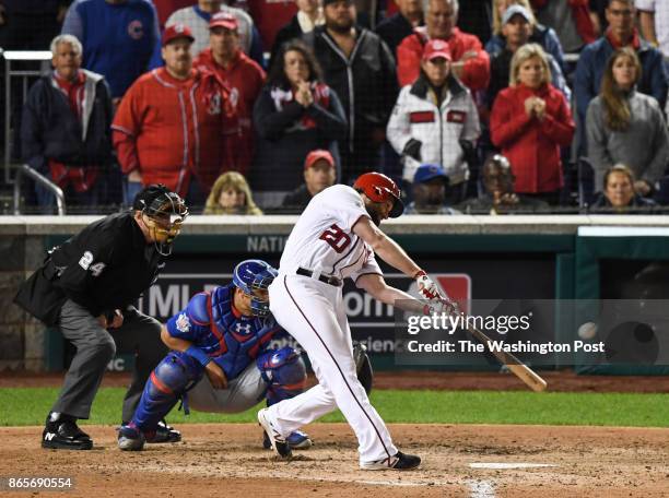 Washington Nationals second baseman Daniel Murphy hits an RBI double during the sixth inning of Game 5 of the National League Division Series between...