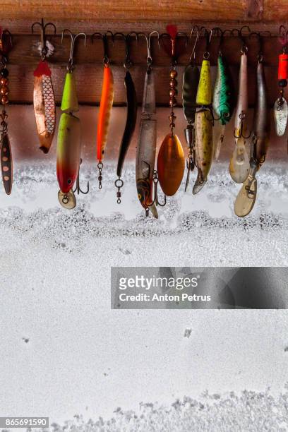 set of different fishing hooks, lures, against the window in the frost - fishing tackle box stockfoto's en -beelden