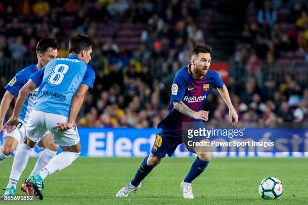 Lionel Andres Messi of FC Barcelona fights for the ball with Juan Pablo Anor Acosta, Juanpi and Adrian Gonzalez Morales of Malaga CF during the La...