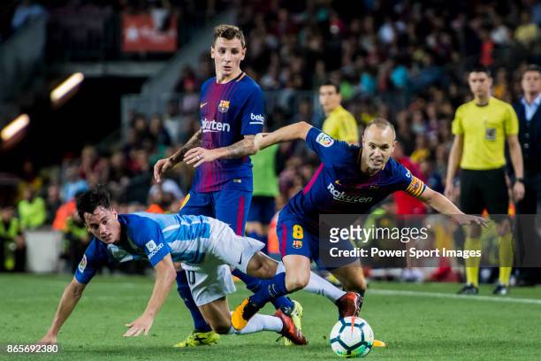 Andres Iniesta Lujan of FC Barcelona fights for the ball with Juan Pablo Anor Acosta, Juanpi , of Malaga CF during the La Liga 2017-18 match between...