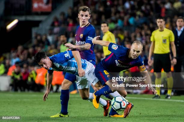 Andres Iniesta Lujan of FC Barcelona fights for the ball with Juan Pablo Anor Acosta, Juanpi , of Malaga CF during the La Liga 2017-18 match between...