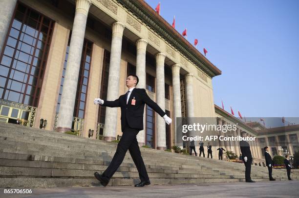 Group of security guards prepare for the closing of the 19th Communist Party Congress outside the Great Hall of the People in Beijing on October 24,...