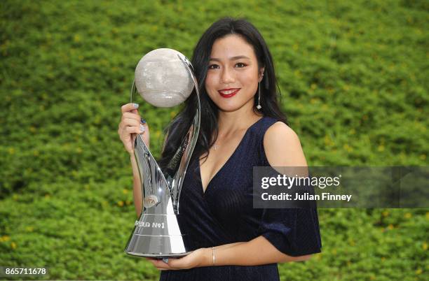 Chan Yung-Jan of Chinese Taipei partnering Martina Hingis of Switzerland poses with the WTA World No.1 Doubles trophy during day 3 of the BNP Paribas...
