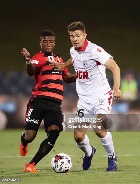 Nathan Konstandopoulos of United is challenged by Roly Bonevacia of the Wanderers during the FFA Cup Semi Final match between the Western Sydney...