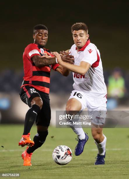 Nathan Konstandopoulos of United is challenged by Roly Bonevacia of the Wanderers during the FFA Cup Semi Final match between the Western Sydney...