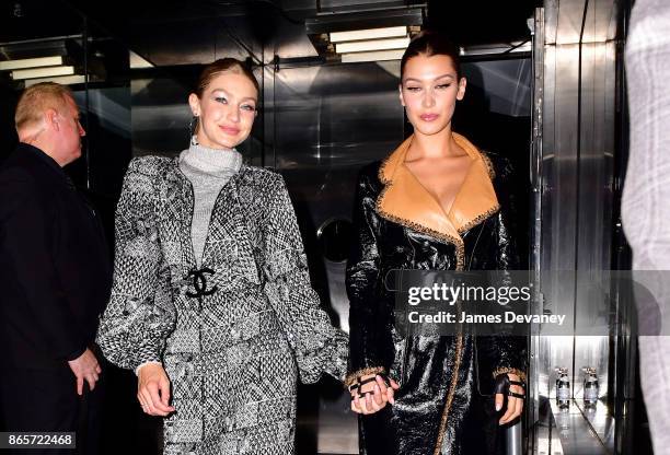 Gigi Hadid and Bella Hadid leave The Top of the Standard on October 23, 2017 in New York City.