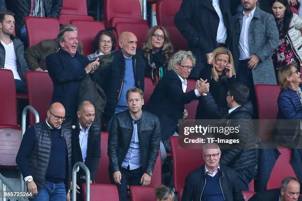 Former German chancellor Gerhard Schroeder sits happy in the stands next to Martin Kind, chairman of Hannover, during the Bundesliga match between FC...