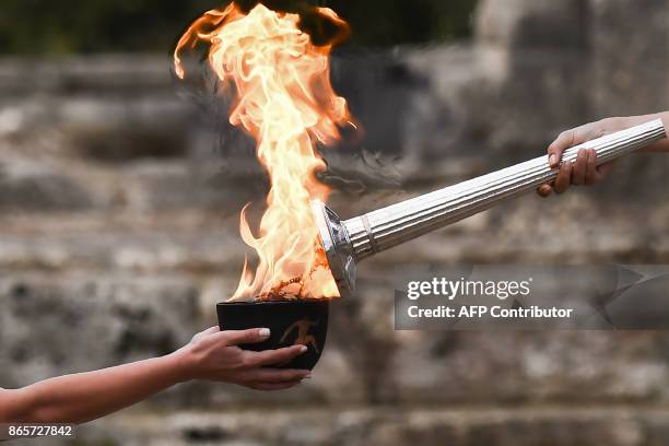 Actress Katerina Lechou , acting the high priestess, lights the Olympic flame at the Temple of Hera in Olympia, the sanctuary where the Olympic Games...