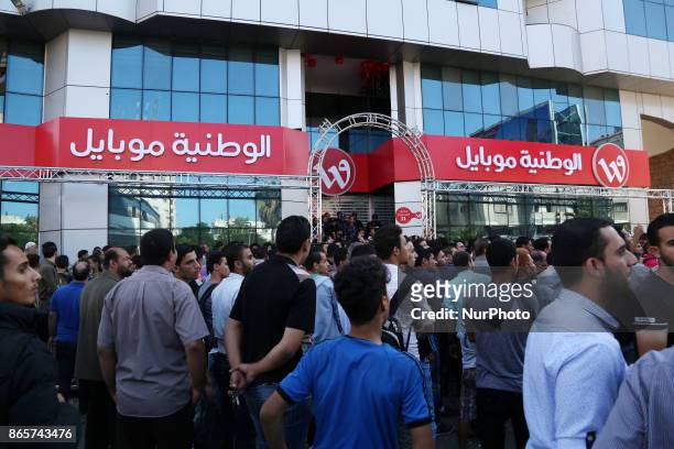 Palestinians wait to get their SIM card from Al-Wataniya Mobile Palestine after it launched services in Gaza City October 24, 2017.