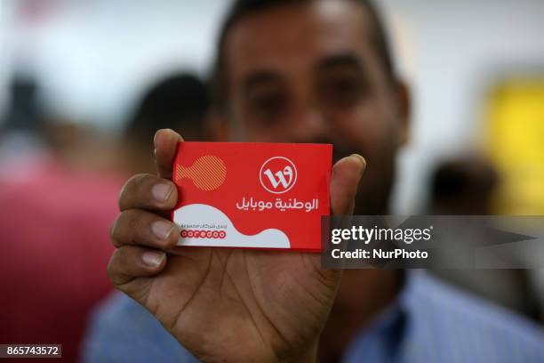 Palestinians wait to get their SIM card from Al-Wataniya Mobile Palestine after it launched services in Gaza City October 24, 2017.