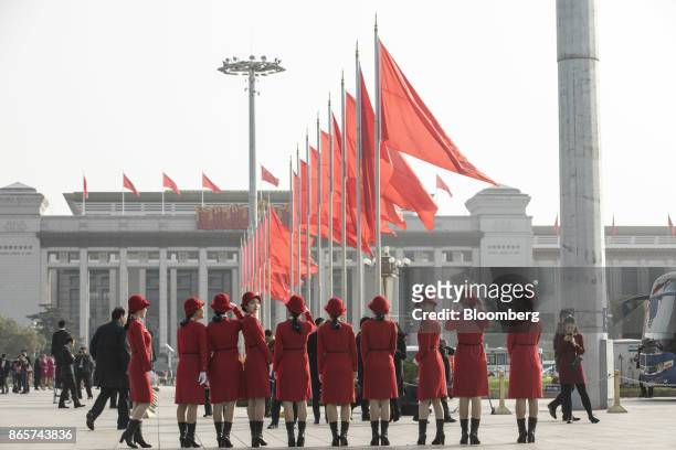 Ceremonial hostesses stand in a line outside the Great Hall of the People ahead of the closing session of the 19th National Congress of the Communist...