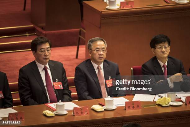 Hu Chunhua, Chinese Communist Party secretary of Guangdong Province, center, attends the closing session of the 19th National Congress of the...