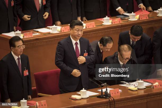 Jiang Zemin, China's former president, second right, is assisted by two attendants as Xi Jinping, China's president, second left, and Hu Jintao,...