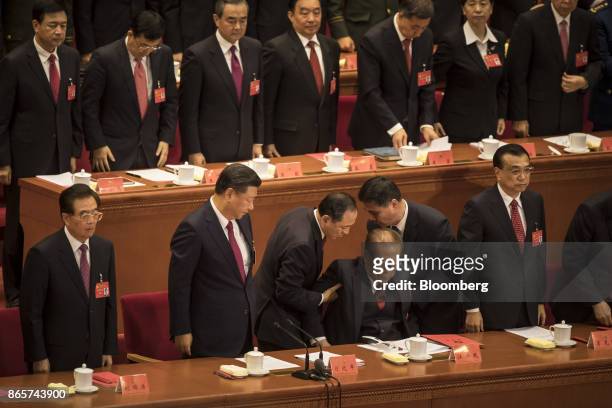 Jiang Zemin, China's former president, third right, is assisted by two attendants as Xi Jinping, China's president, second left, Hu Jintao, China's...