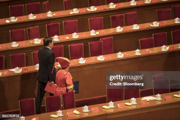 Delegates leave at the conclusion of the closing session of the 19th National Congress of the Communist Party of China at the Great Hall of the...