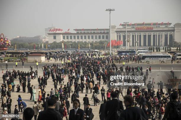 Delegates and members of the media leave the Great Hall of the People following the closing session of the 19th National Congress of the Communist...