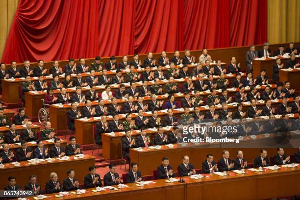 Xi Jinping, China's president, front row center, and other leaders and delegates attend the closing session of the 19th National Congress of the...
