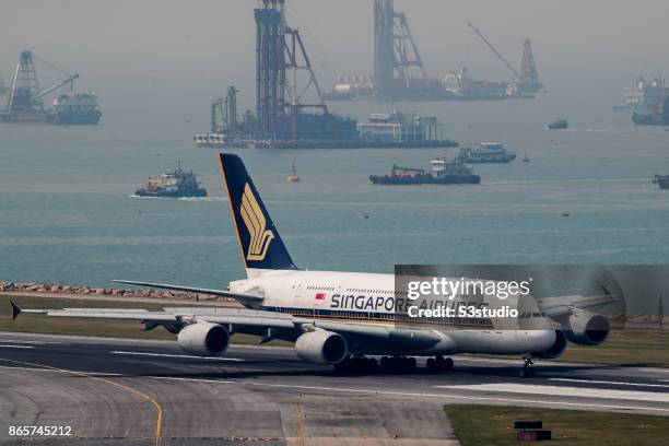 An Airbus A380 passenger plane belonging to the Singapore Airlines taxis down the runway at Hong Kong International Airport, on 23 October 2017, in...