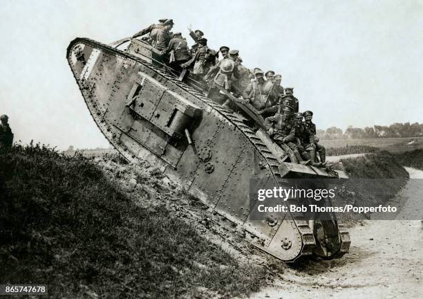 Canadian soldiers climbing the side of a sunken road in their tank during World War One, circa 1916.